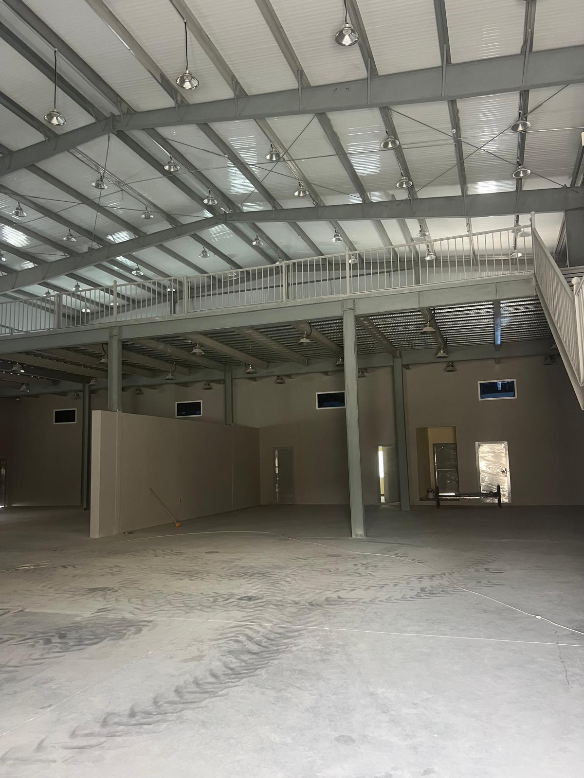 Warehouse interior with a steel mezzanine and railings